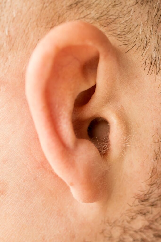 pexels-photo-6319017-6319017 Detailed close-up of a human ear showcasing skin texture and anatomy.